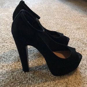 Black Steve Madden platform peep toe heels.